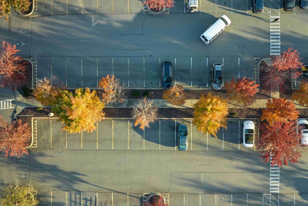 View from above of many parked cars on parking lot